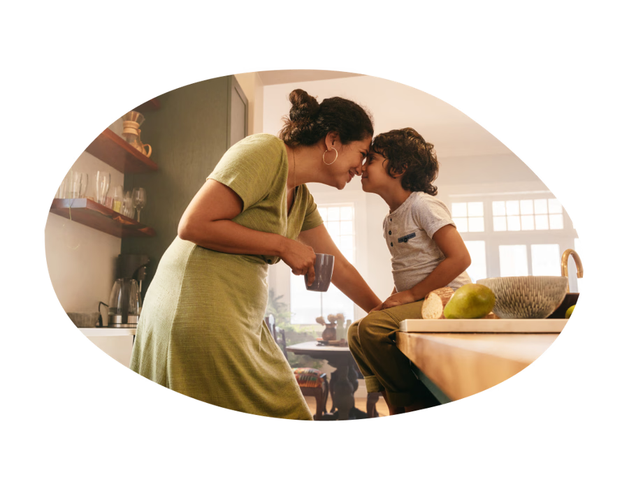 Mother holding coffee mug bonding with young son